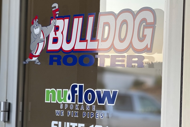 Bulldog Rooter and NuFlow Spokane logo on a door