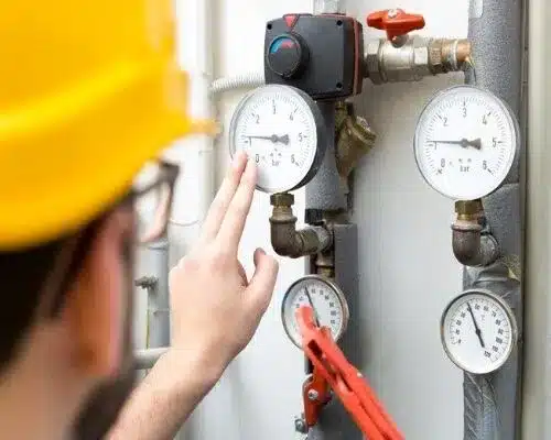 A technician working on a water pressure system