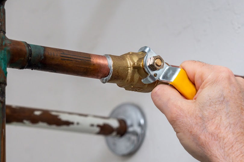 A technician making adjustment on a pipe