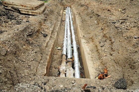 An image of undergrown pipes exposed after a trench was dug to accommodate them