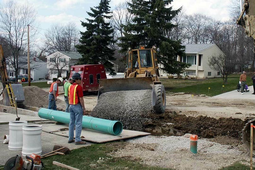 A plumbing crew replacing a main sewer line