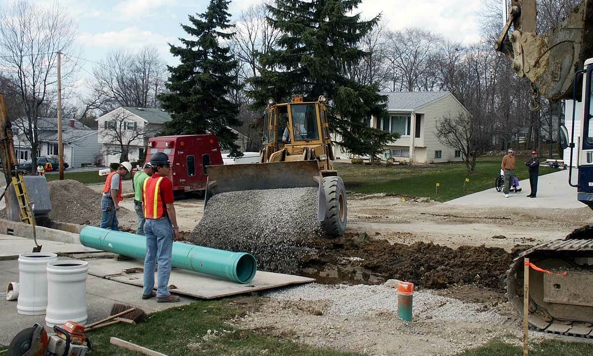 A plumbing crew replacing a main sewer line