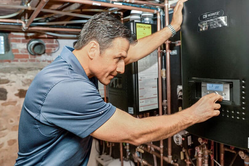 A technician working on a water heater