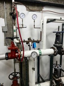 Backflow installation with pressure gauges and shutoff valves in Spokane facility