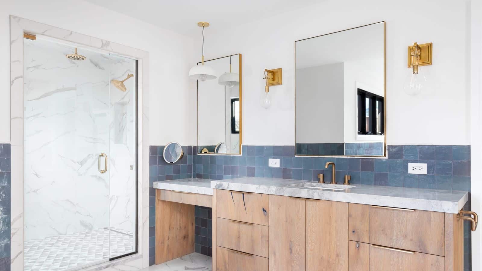 A modern bathroom with glass shower wall in pristine condition