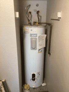 Old water heater in apartment closet before replacement in Spokane Valley WA