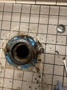 Toilet removed to expose flange with buildup