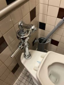 A commercial toilet with a new flush handle